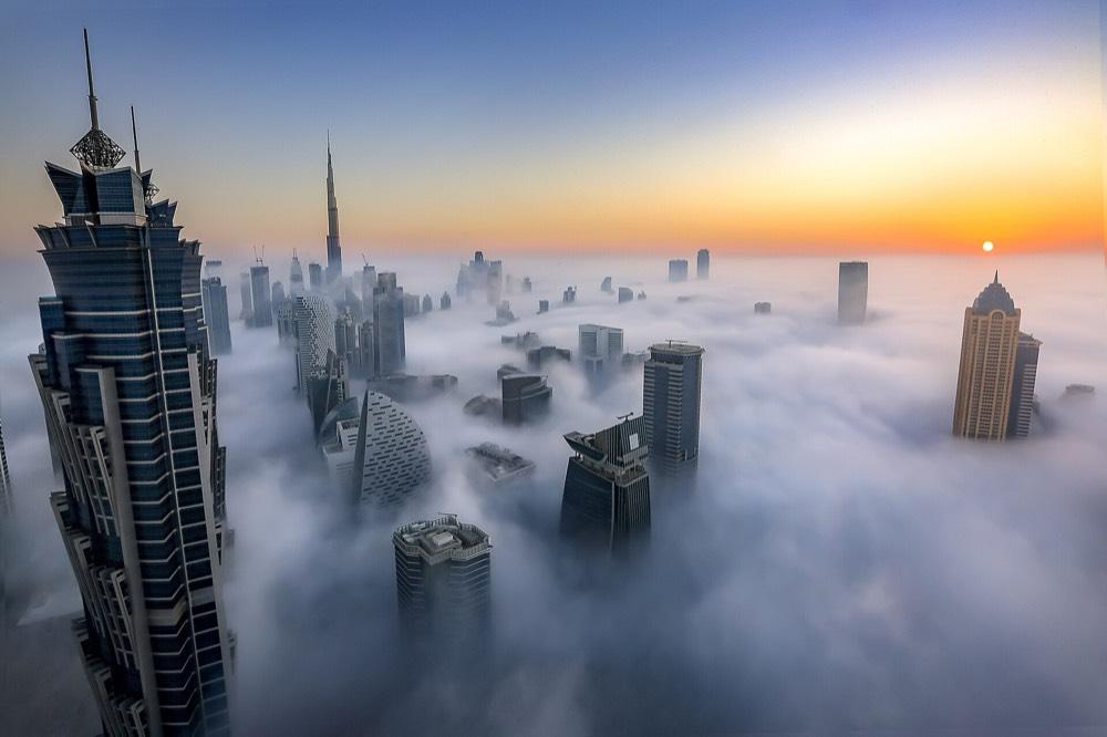 Dubai towers rising above morning fog